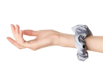 Poster Female hand with trendy silk scrunchy on white background © Pixel-Shot