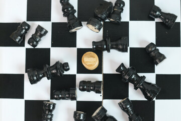 Top View of One King Chess as A Winner with Black Chess Pieces Falling on Chessboard 
