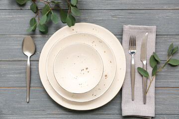 Beautiful table setting with leaves on grey wooden background - obrazy, fototapety, plakaty