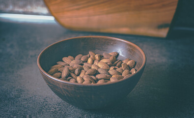 Almonds in a clay plate on the table