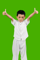 Asian kid shows two thumbs up isolated over green background