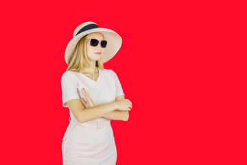Fashionable confident woman wearing sunglasses and hat