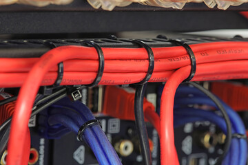 Plastic ties that tighten electrical wiring harnesses. Close-up.