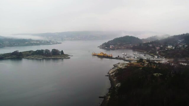 Aerial of Ferry at Shore a Foggy Day, Orust, Sweden