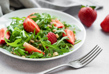 Fresh Strawberry Arugula Salad With Pine Nuts Served on a Bright Day