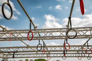 Outdoor sport. Parkour element: rings on scaffolding in the park. Training grip strength for...