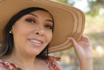 Selfie of woman wearing sun hat. Close-up portrait.