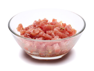Fototapeta na wymiar Sliced and chopped tuna fillet in glass bowl isolated on white background