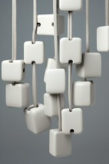White cubes hanging on a rope on a gray background,   rendering