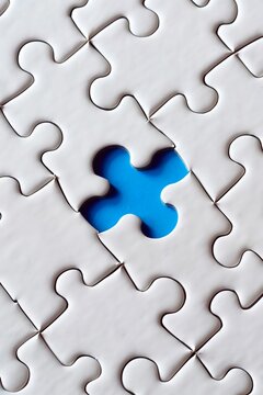 A white jigsaw puzzle with one blue piece, symbolizing the concept of halfdenska, with a closeup view focusing on that single blue space in an allwhite background The focus is on highlighting how each