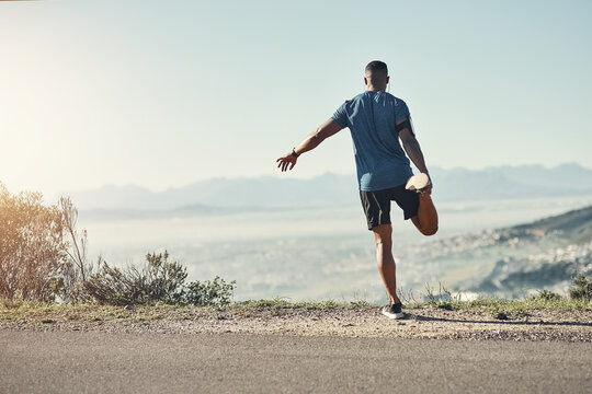 Black man, stretching and outdoor for exercise, running and fitness with nature for upcoming athletic competition. Athlete, warm up and road for workout, jog and training with mountain top view
