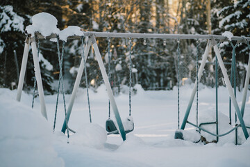 Thick snow covers a playground in Alaska, America.