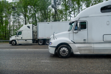 Large White American Truck is moving along a country highway in Atlanta, United States,