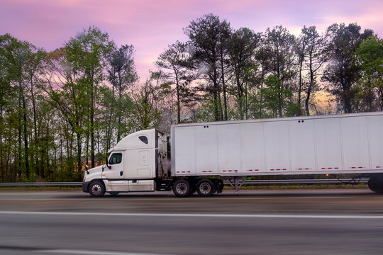 Fototapeta Large White American Truck is moving along a country highway in Atlanta, United States,