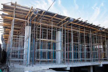 Construction site with scaffolding and floor formwork.