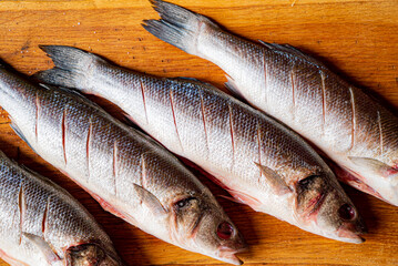 raw sea bass on wooden background