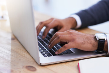 Hands, laptop keyboard and desk for typing email, online research and business communication....