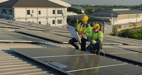 Technicians engineer in safety vests and helmets discussing analysis maintenance install solar...