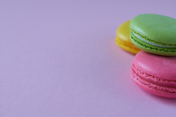 Colorful macaroons on a pink background. Copy space.
