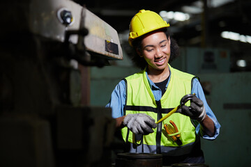factory worker using tape measure and measuring spare parts in the factory