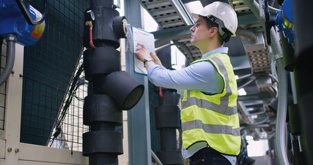 Civil engineer manager checking industry cooling air conditioner water cooling tower air chiller of...