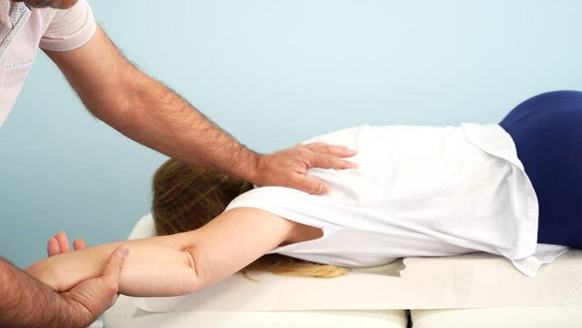 Blonde woman in a physiotherapy session to help relieve arm pain