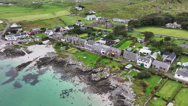 Iona, Scotland UK. Aerial View of Waterfront Homes, Houses and Green Landscape, Drone Shot 60fps