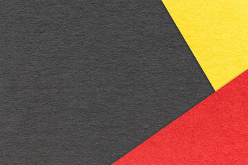 Texture of craft black color paper background with red and yellow border. Vintage abstract...