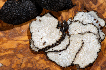 Slices of Italian black summer truffle, tasty aromatic mushroom, close up