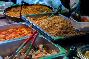 Local asian food, singapore noodle and rice dish with vegetables, fried shrimps and chicken meat