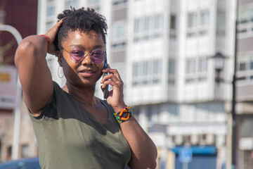 black woman posing with mobile phone on the street