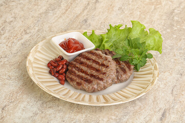 Grilled beef burger cutlet with sauce