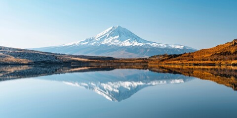 Mountain Reflection: A still mountain lake with a perfect reflection of a snow-capped peak in its center.