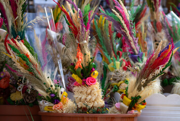 Easter Fair booth, selling traditional Easter palms. Seasonal bazaar with folk art vendors and food stalls or stands. Jarmark wielkanocny in Poland.
