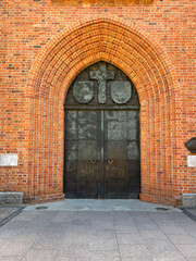 a door in a brick wall Old-fashioned brick facade