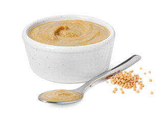 Fresh tasty mustard sauce in bowl and spoon with dry seeds isolated on white