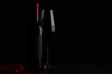 Tasty wine in glass and bottle on black background, space for text