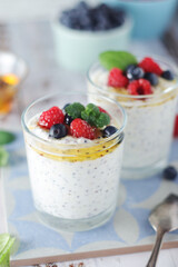 Greek yogurt in glasses with berries and quinoa