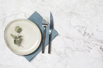 Stylish setting with elegant cutlery on white marble table, top view. Space for text