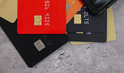 Pile of different credit cards on grey table, top view