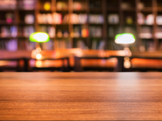 Table top with lighting Blur bookshelf Library interior background