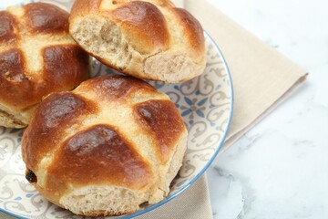 Hot cross buns on white marble table, closeup