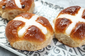 Tasty hot cross buns on table, closeup