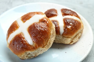 Tasty hot cross buns on gray table, closeup