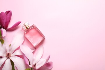 Obraz na płótnie Canvas Beautiful magnolia flowers and bottle of perfume on pink background, flat lay. Space for text