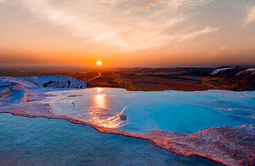 Natural travertine pools and terraces in Pamukkale at sunset ( Cotton castle) - Denizli,...