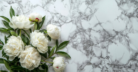 A bouquet of white flowers sits on a marble countertop