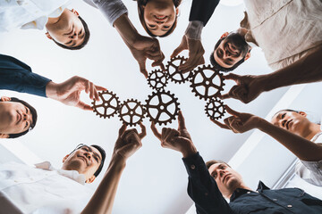 Business team joining cogwheel in circular together symbolize successful group of business...