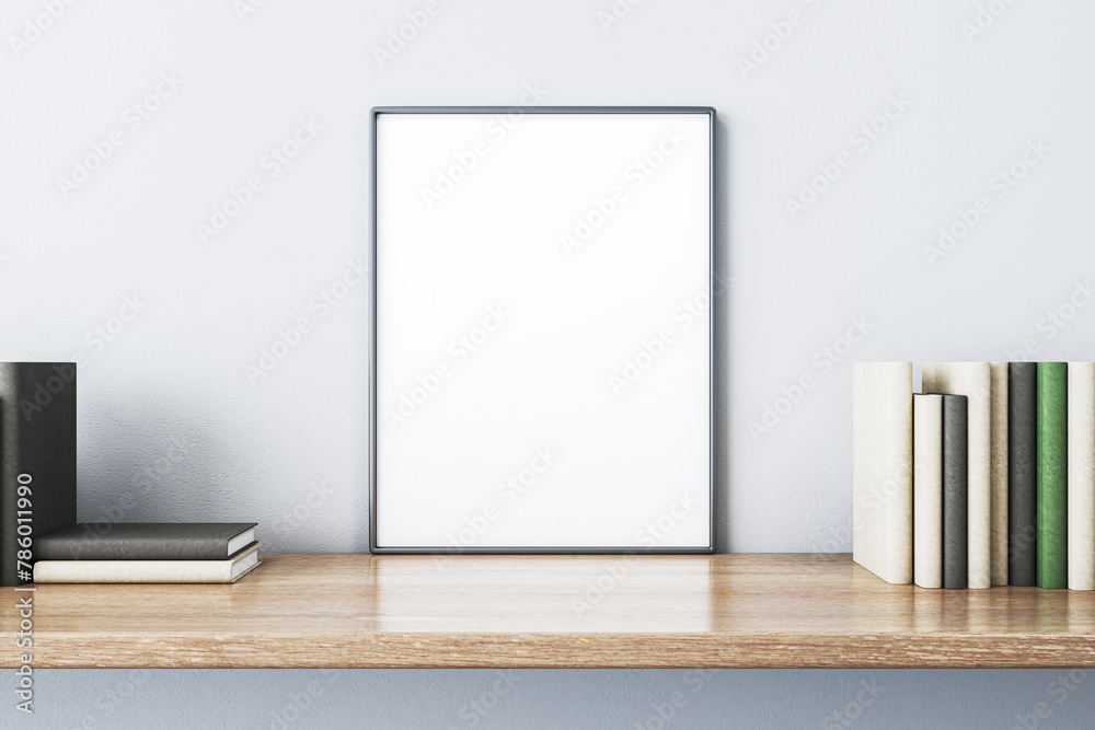 Poster close up of creative wooden designer desk with books and empty white mock up banner on light concret