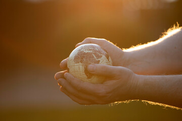 Hand holding a world globe. Earth Day environment concept.